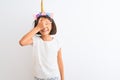 Beautiful child girl wearing unicorn diadem standing over isolated white background smiling and laughing with hand on face Royalty Free Stock Photo