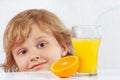 Beautiful child with a glass of fresh juice and orange