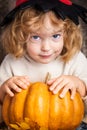 Beautiful child holding a pumpkin