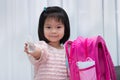 Beautiful child pack bags to go back to school after the virus outbreak subsides.