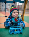 Beautiful child on the playground area in the winter Royalty Free Stock Photo