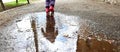 Beautiful child in the rain, children playing save with water, childhood games outside Royalty Free Stock Photo