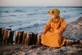 Beautiful child sitting on breakwater on baltic sea Royalty Free Stock Photo