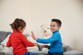 Happy boy and girl claping their hands while playing together