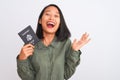 Beautiful chinese woman holding USA United States passport over isolated white background very happy and excited, winner Royalty Free Stock Photo