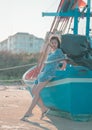 Beautiful Chinese woman standing on a fishing boat side on a Thailand island beach Royalty Free Stock Photo