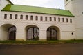 Beautiful Christian white church hall with archs, green roof beside green grass lawn and asphalt road.