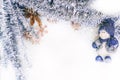 Beautiful Christmas background. Figure of a porcelain snowman in a blue hat on a white background. Shiny Christmas tinsel and Royalty Free Stock Photo