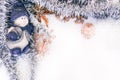 Beautiful Christmas background. Figure of a porcelain snowman in a blue hat on a white background. Shiny Christmas tinsel and Royalty Free Stock Photo