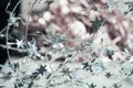 Beautiful Christmas background from silver twisted wire with stars on a blurred pale pink. Magical New Year mood Royalty Free Stock Photo
