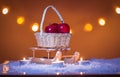 Christmas background with sleigh, basket with red apples, candles, snow, stars and bokeh lights Royalty Free Stock Photo