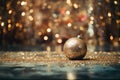 Beautiful christmas ball on golden shine particles for a holiday celebration. Wallpaper for ads and web design Royalty Free Stock Photo