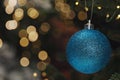 Beautiful Christmas ball hanging on fir tree branch against blurred background, closeup. Space for text Royalty Free Stock Photo