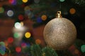 Beautiful Christmas ball hanging on fir tree branch against blurred background, closeup. Space for text Royalty Free Stock Photo