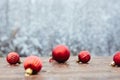 Beautiful Christmas bauble decorations lie on the wooden table over snow covered forest background Royalty Free Stock Photo