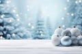 Beautiful Christmas blue balls on a snowy forest background.Empty wooden table against a beautiful snowy background with Christmas