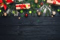 Beautiful Christmas composition with gift boxes, festive decorations and space for text on black wooden table, flat lay. Bokeh Royalty Free Stock Photo