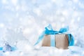 Beautiful Christmas composition with gift or present box in snow and decoration against holiday lights background Royalty Free Stock Photo