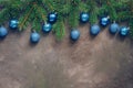 Beautiful Christmas composition, spruce branches decorated with blue balls on a dark rustic background, border. Top view, flat lay Royalty Free Stock Photo