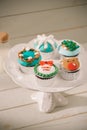 Beautiful Christmas cupcakes decorated fairy-tale figures close-up on the table. horizontal