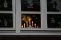 Beautiful christmas decoration with candles in the window Royalty Free Stock Photo