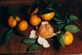 Beautiful Christmas decoration with tangerines in the night light garlands. Citrus still life. The symbol of the new year Royalty Free Stock Photo