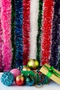 Beautiful Christmas decorations, toys, beads, balls in a box in foreground. There are gift bags