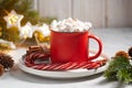 Beautiful christmas drink in the red cup with marshmallows and cinnamon with anis stars close-up Royalty Free Stock Photo