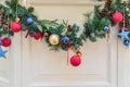 Beautiful christmas garland decorated with fur tree branches. multicolored baubles and cones. Interior holiday decoration Royalty Free Stock Photo