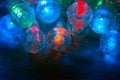 Beautiful Christmas garland glowing in the dark. Led holiday light with glass balls Royalty Free Stock Photo