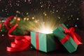 Beautiful Christmas gift box with magic light on table Royalty Free Stock Photo