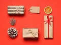 Beautiful Christmas gift boxes with ribbons and decors on color background