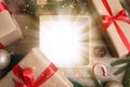 Beautiful Christmas gift with magic light on wooden background, flat lay Royalty Free Stock Photo