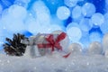 Christmas composition with gift or present box and decorative snowballs against holiday lights background Royalty Free Stock Photo