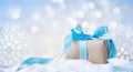 Beautiful Christmas gift or present box in snow and decoration against holiday lights background Royalty Free Stock Photo