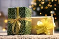 Beautiful Christmas gifts with golden bows on carpet indoors Royalty Free Stock Photo