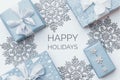 Beautiful christmas gifts and silver snowflakes isolated on white background. Pastel blue colored wrapped xmas boxes.