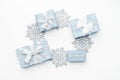 Beautiful christmas gifts and silver snowflakes isolated on white background. Pastel blue colored wrapped xmas boxes. Royalty Free Stock Photo