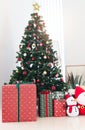 Beautiful Christmas gifts under Christmas tree at living room, Xmas and new year home decorations, festive tree decorated with Royalty Free Stock Photo