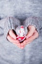 Beautiful Christmas glass snowball in female hands on background