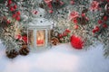 Beautiful Christmas lantern with candle and fir branches with cones and red berries in snow. Atmospheric winter scene with copy