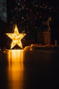 Beautiful Christmas living room with decorated tree, gifts and glowing lights at night. Royalty Free Stock Photo