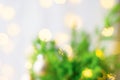 Beautiful Christmas New Year Blurred Background. Decorated fir tree branches golden garland bokeh lights. Festive atmosphere