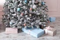 Beautiful Christmas presents near Christmas tree in living room. New Year 2020. Pink and blue gift boxes with ribbons. holiday de