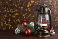 Beautiful Christmas snow globe in vintage lantern and festive decor on wooden table. Space for text Royalty Free Stock Photo