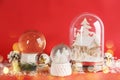 Beautiful Christmas snow globes on red background, bokeh effect