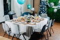 A beautiful Christmas table is set for a family dinner. Everything is decorated with balloons. Royalty Free Stock Photo