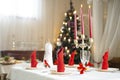 Beautiful Christmas table setting background with fir tree on a backdrop Royalty Free Stock Photo