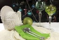 Beautiful Christmas table setting in front of Christmas Tree, with green crystal wine goblet glasses Royalty Free Stock Photo