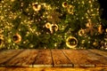 Beautiful Christmas tree backdrop and lights with top of empty wood table. Royalty Free Stock Photo